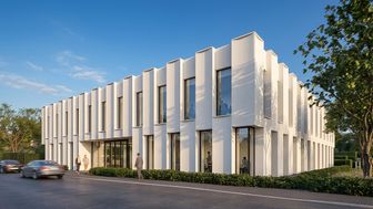 Corner view of the office building in daylight, showing the white precast concrete fins across both storeys
