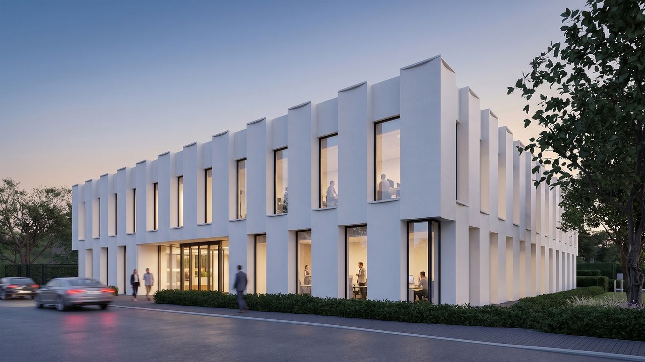 Office building in Kortenberg at dusk — white precast concrete fins with warm light behind the windows